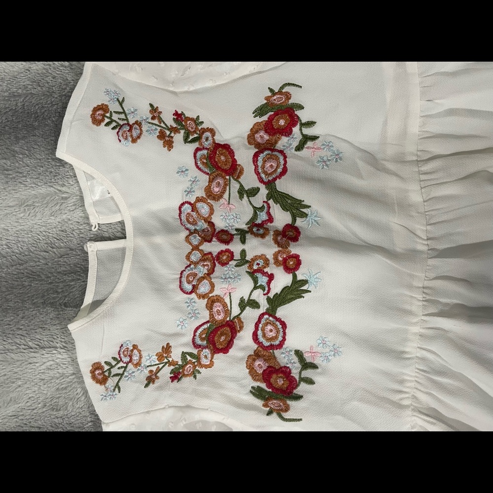 Beautiful white top with flower designs on the front